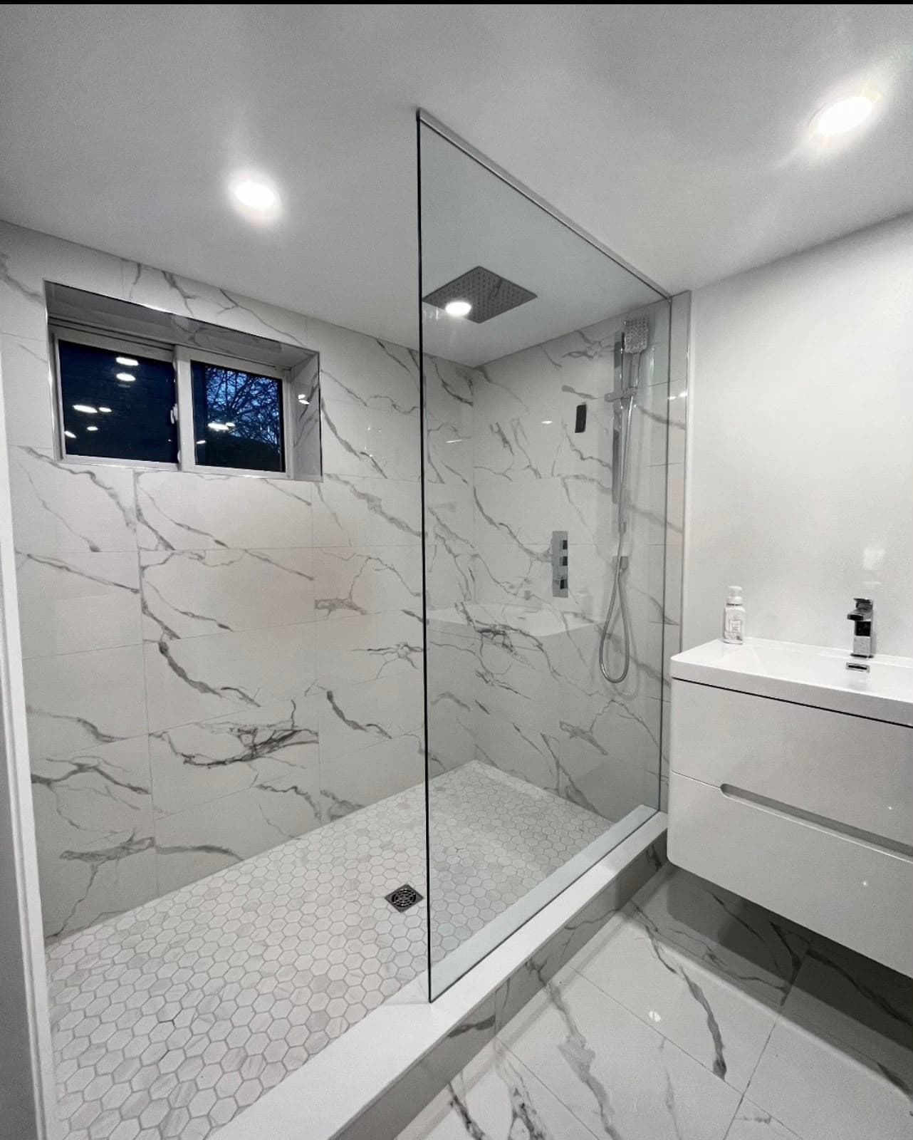 Luxury walk-in shower with marble-look tile installed by Costa Bathroom Remodel in Sun City Center, Florida